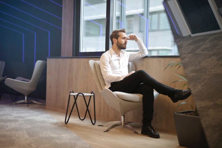  3D Marketing Specialist Sitting on a Chair by the Window