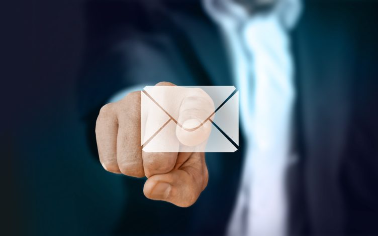 A Businessman Pointing to an Electronic Letter Icon