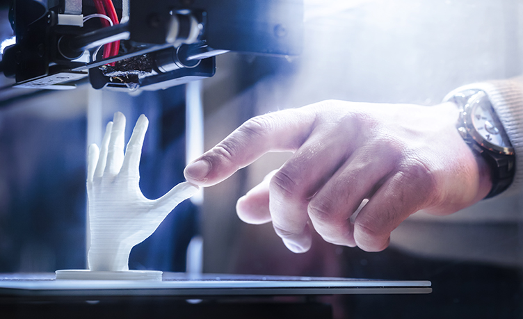 Person Using a 3D Printer to Create a Human Hand Model