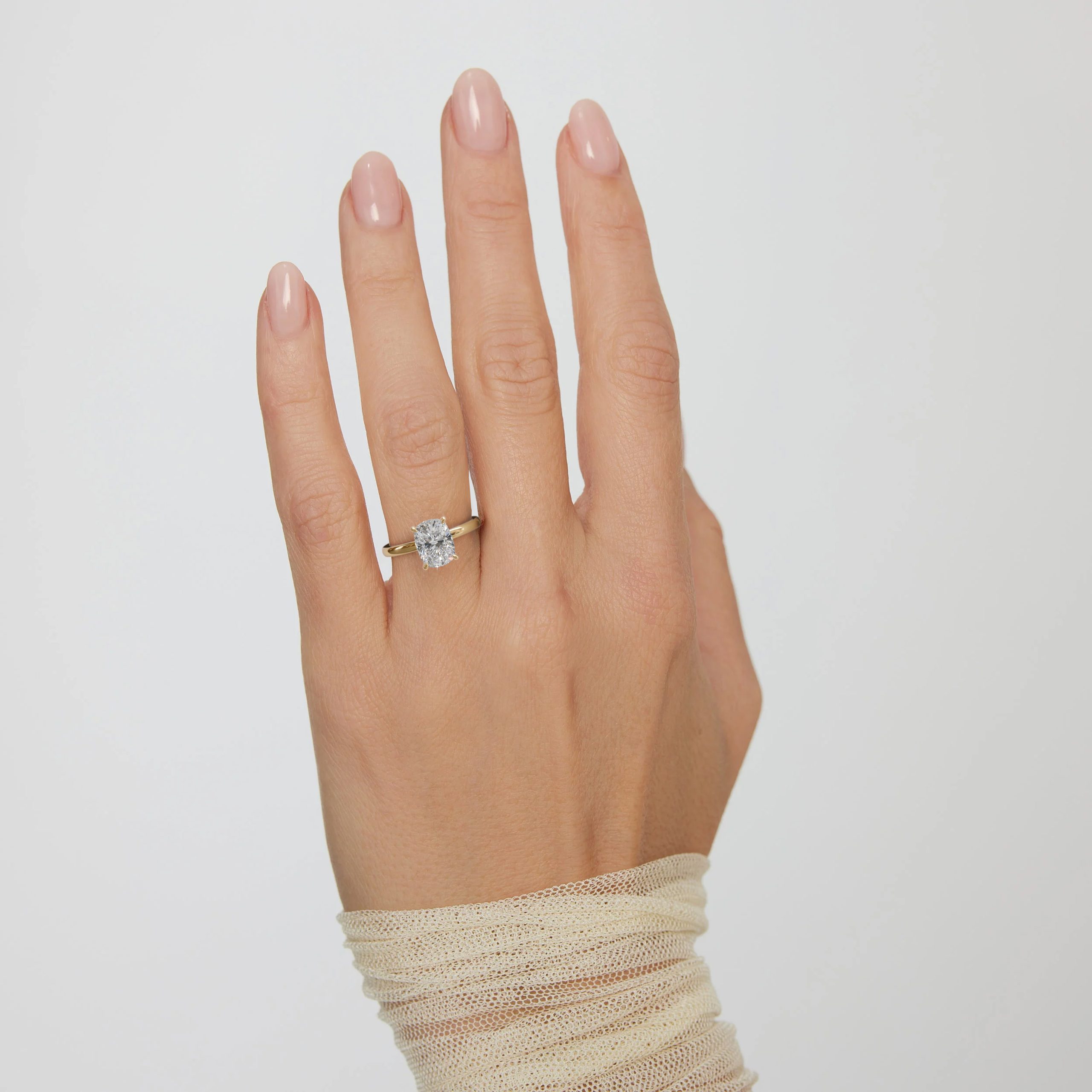 3D render of a hidden halo ring in yellow gold on a hand